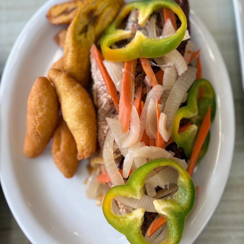 Escovitch fish topped with peppers, carrots and onions.